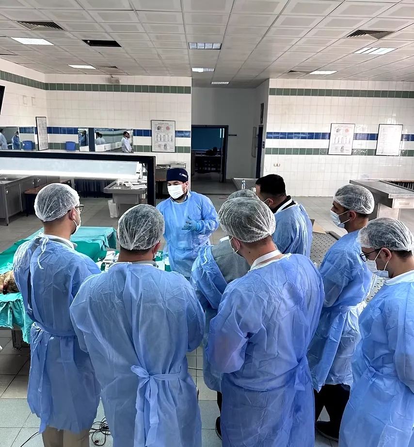 Assoc. Prof. Dr Tuncay Tas briefing course participants around the cadaveric training table at Dr Tas Clinic, Istanbul