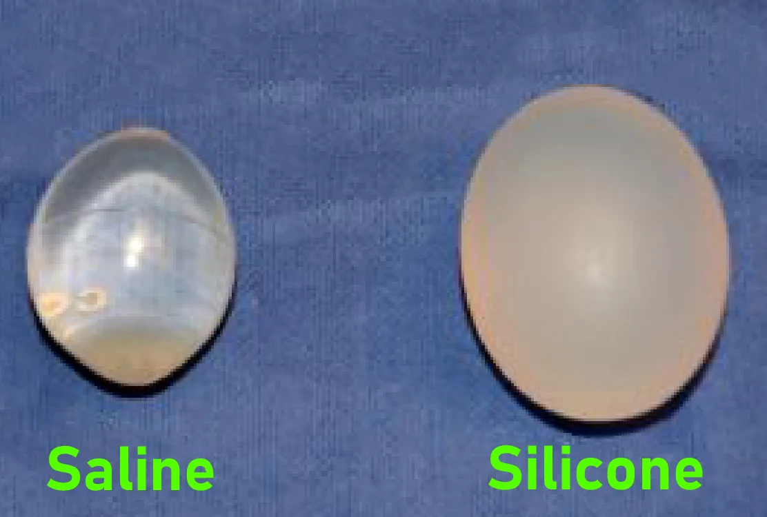 A saline filled testicular implant beside a silicone gel implant, showing the difference in translucency and surface